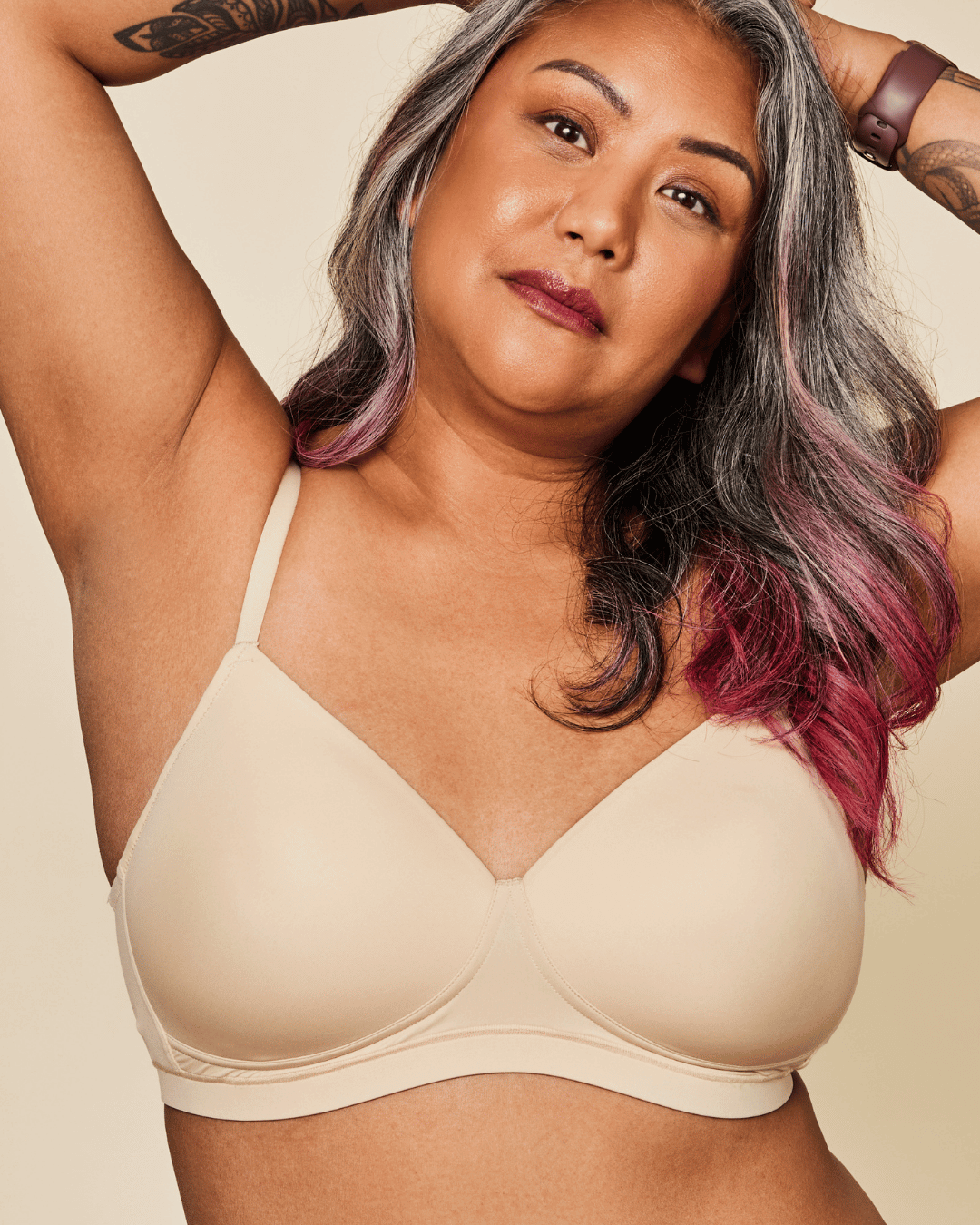 Woman wearing a beige bra against a beige background