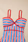 Red, white, and blue striped swimsuit on a beige background