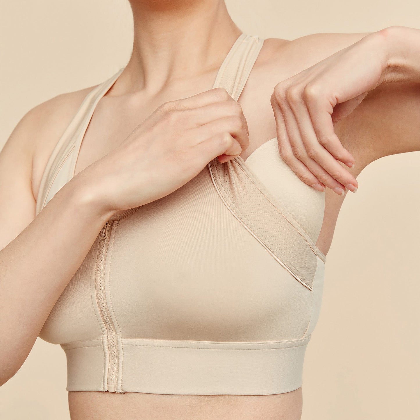 Beige compression garment being worn by a person on a beige background